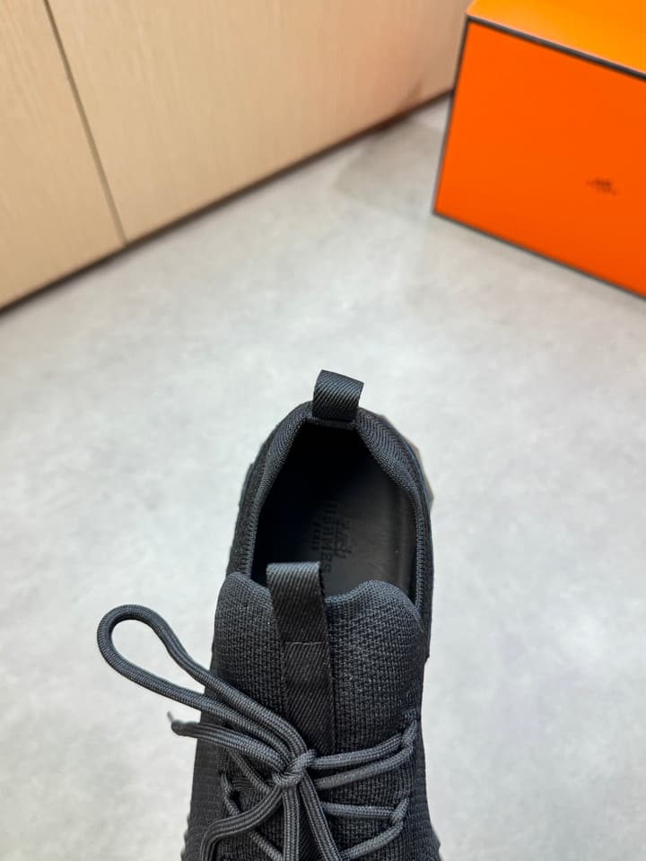Hermès Casual Sports Sneakers in Black With White Laces And Orange Sole
