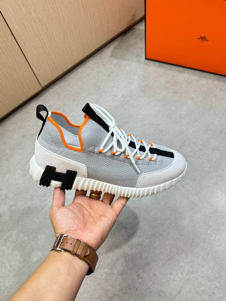 Hermès Casual Sports Sneakers in Black With White Laces And Orange Sole