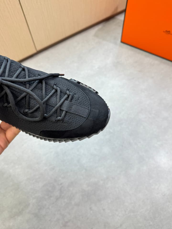 Hermès Casual Sports Sneakers in Black With White Laces And Orange Sole