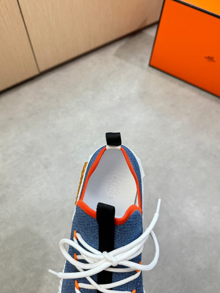 Hermès Casual Sports Sneakers in Black With White Laces And Orange Sole