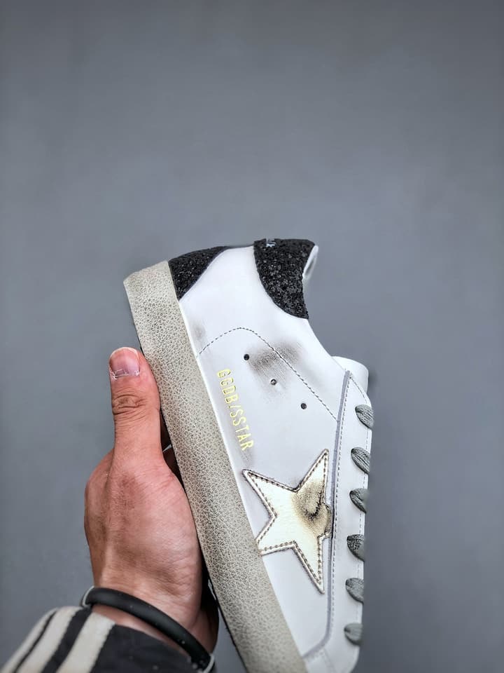 Golden Goose Distressed Sneakers in Gold