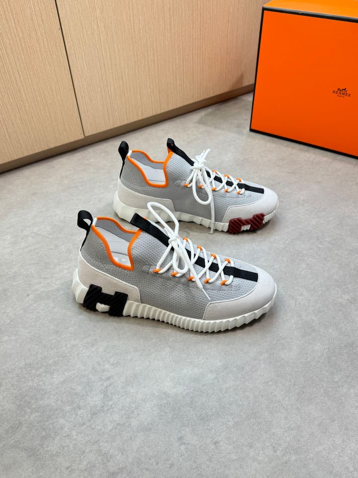 Hermès Casual Sports Sneakers in Black With White Laces And Orange Sole