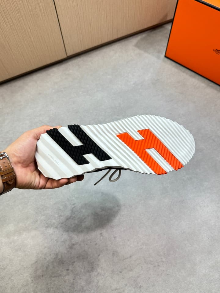 Hermès Casual Sports Sneakers in Black With White Laces And Orange Sole
