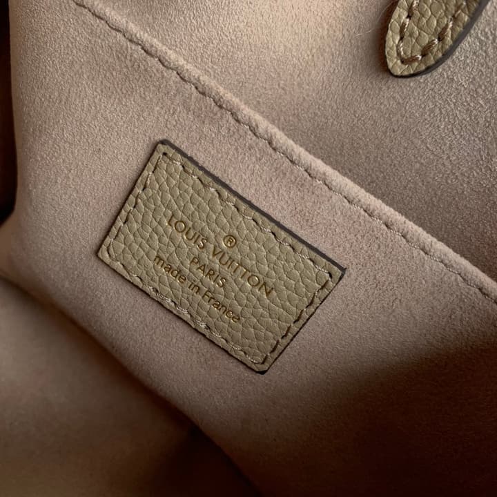 Louis Vuitton OnTheGo BB Monogram Empreinte Handbag in Beige And Cream Monogram