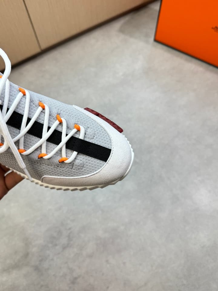 Hermès Casual Sports Sneakers in Black With White Laces And Orange Sole