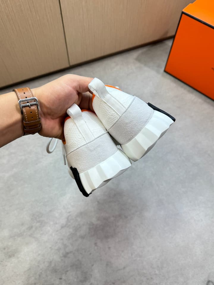 Hermès Casual Sports Sneakers in Black With White Laces And Orange Sole