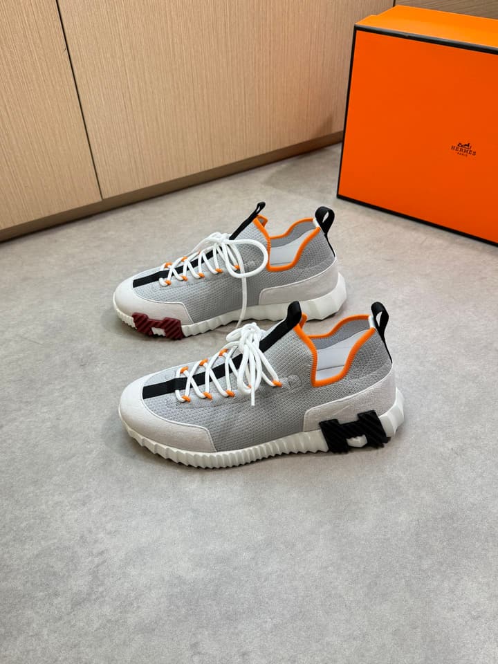 Hermès Casual Sports Sneakers in Black With White Laces And Orange Sole