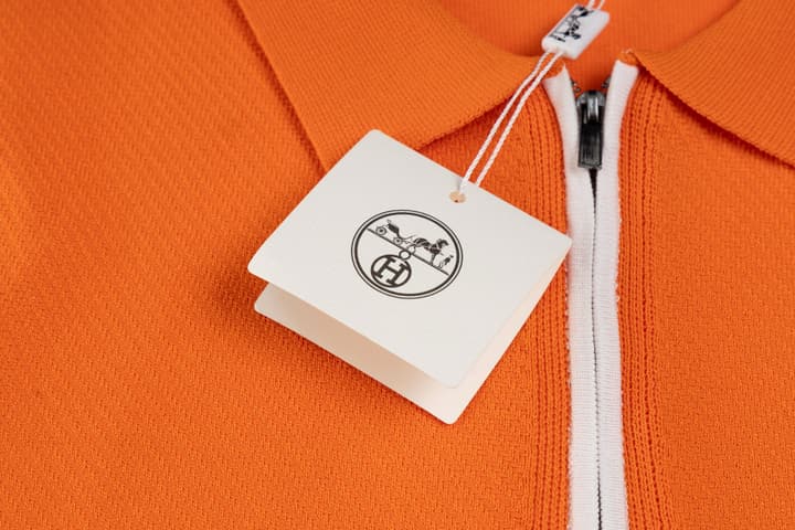 Hermès Retro Knitted Polo Shirt – SS24 in Black Polo With Orange Placket