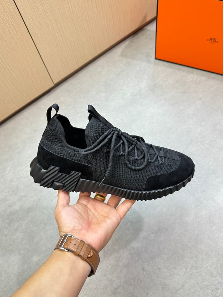Hermès Casual Sports Sneakers in Black With White Laces And Orange Sole