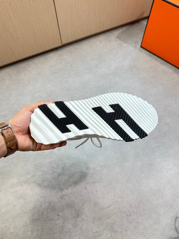 Hermès Casual Sports Sneakers in Black With White Laces And Orange Sole