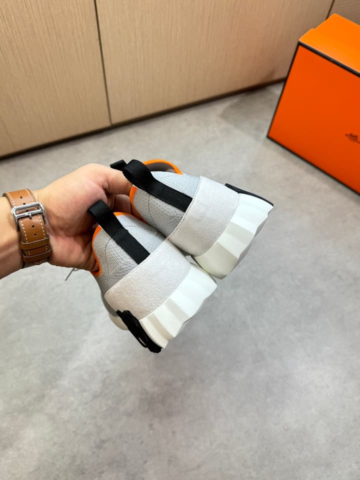 Hermès Casual Sports Sneakers in Black With White Laces And Orange Sole