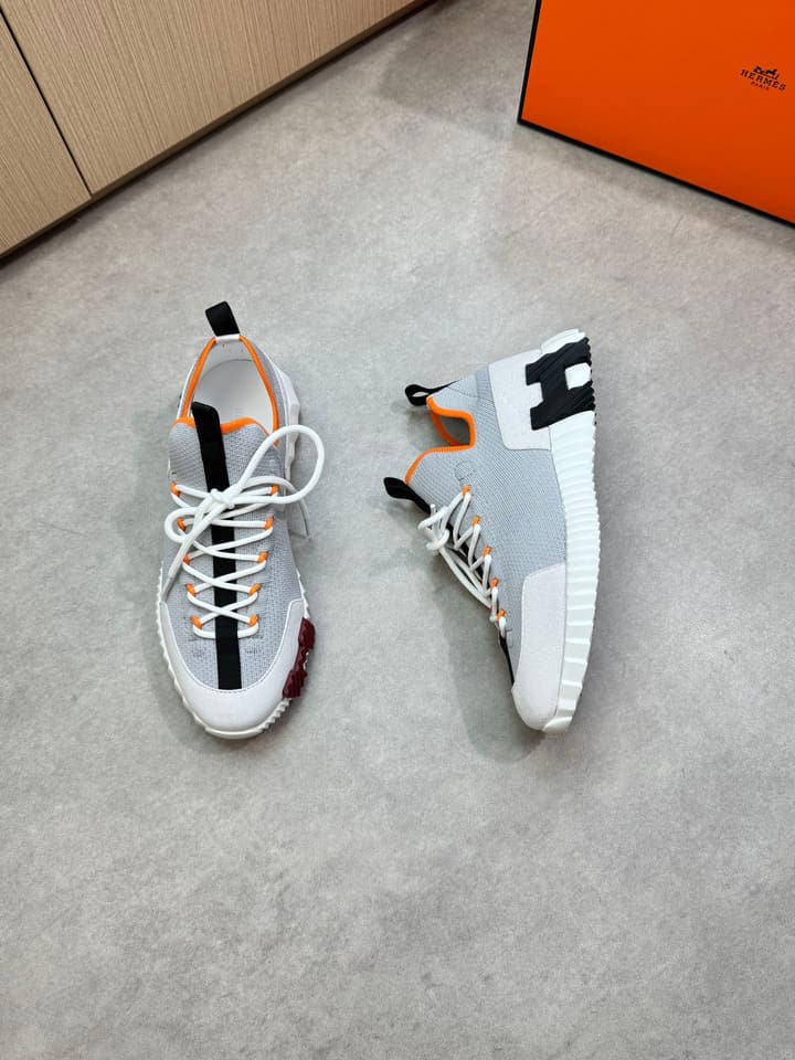 Hermès Casual Sports Sneakers in Black With White Laces And Orange Sole