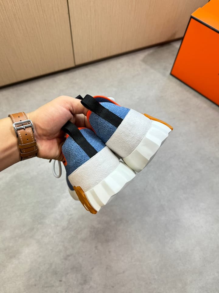 Hermès Casual Sports Sneakers in Black With White Laces And Orange Sole