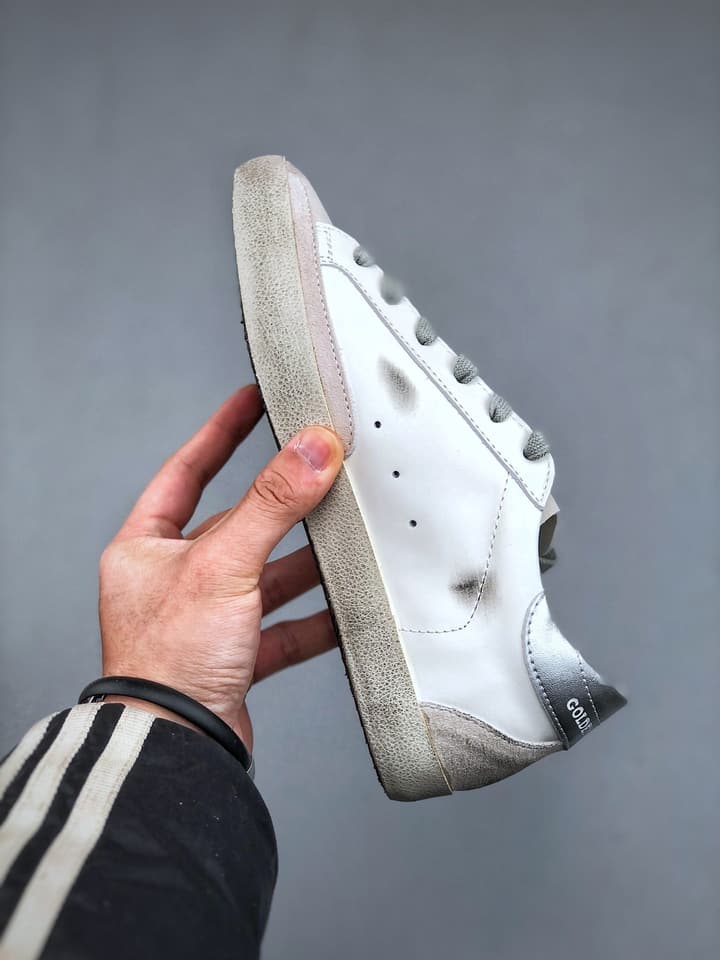 Golden Goose Distressed Sneakers in Gold