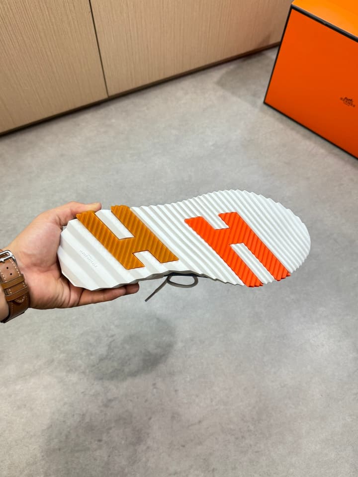 Hermès Casual Sports Sneakers in Black With White Laces And Orange Sole