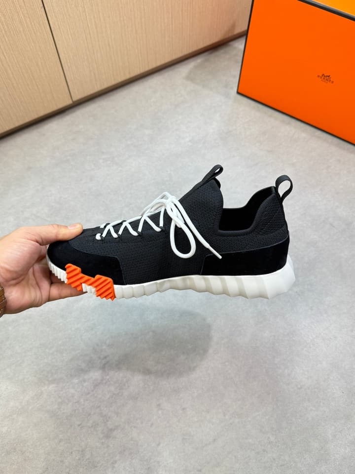 Hermès Casual Sports Sneakers in Black With White Laces And Orange Sole