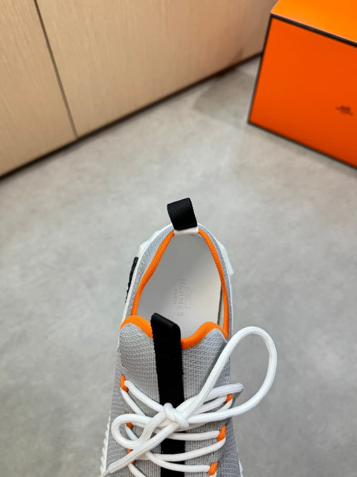 Hermès Casual Sports Sneakers in Black With White Laces And Orange Sole