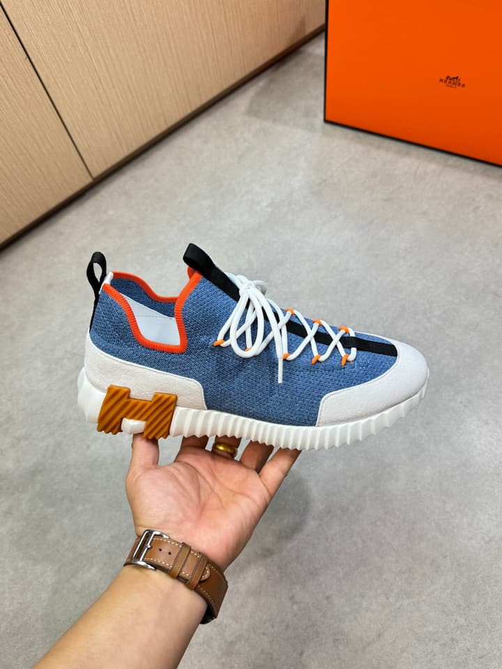 Hermès Casual Sports Sneakers in Black With White Laces And Orange Sole