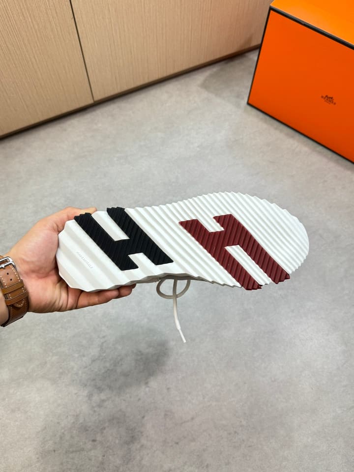 Hermès Casual Sports Sneakers in Black With White Laces And Orange Sole