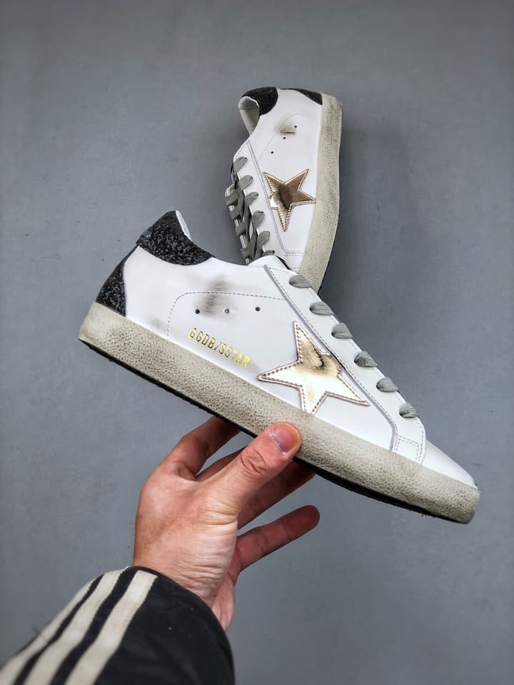 Golden Goose Distressed Sneakers in Gold
