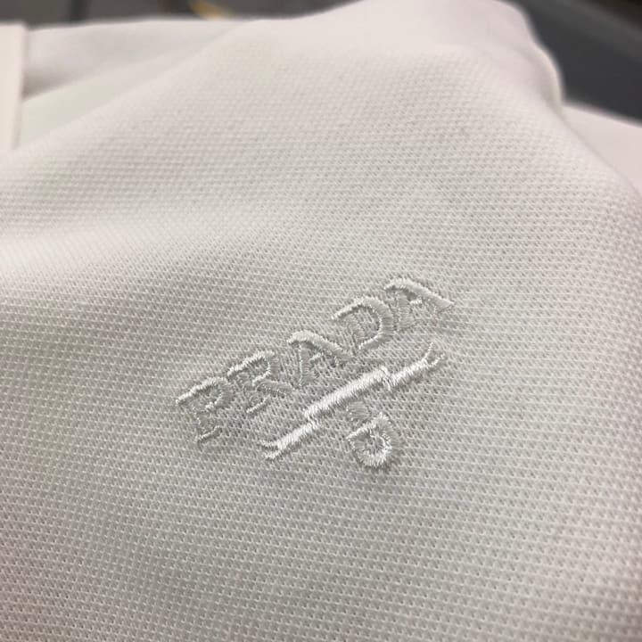 Prada Embroidered Triangle Logo Polo Shirt – 2026SS in Black