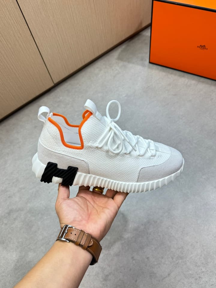 Hermès Casual Sports Sneakers in Black With White Laces And Orange Sole