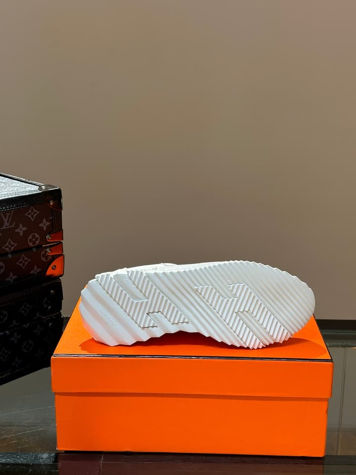 Hermès Bouncing Calfskin Mesh Sneakers in Black With White Stripe