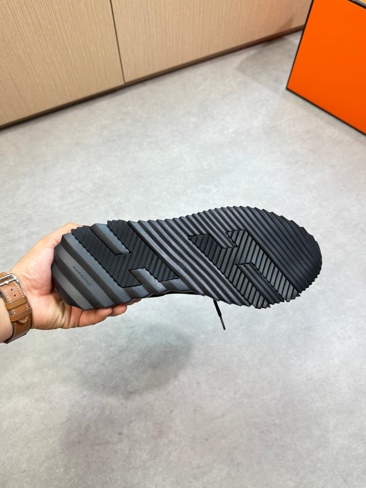 Hermès Casual Sports Sneakers in Black With White Laces And Orange Sole