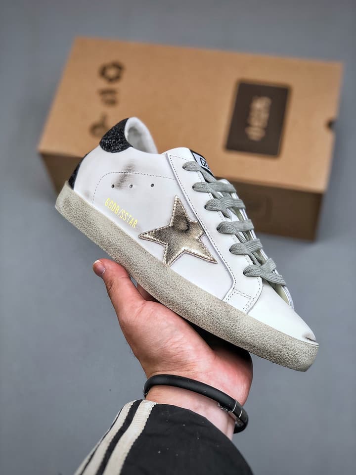 Golden Goose Distressed Sneakers in Gold
