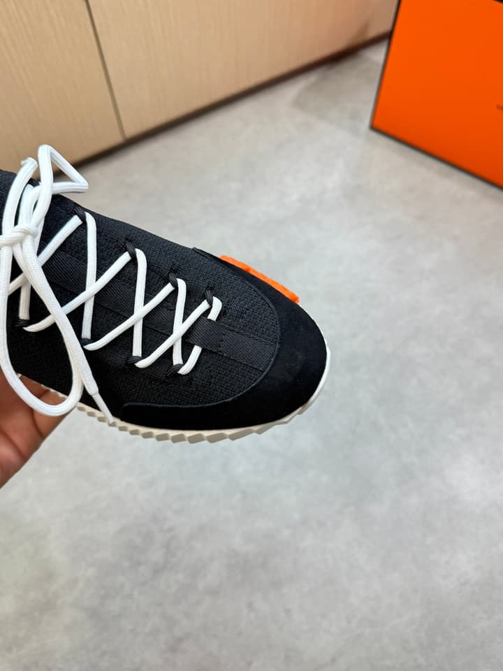 Hermès Casual Sports Sneakers in Black With White Laces And Orange Sole