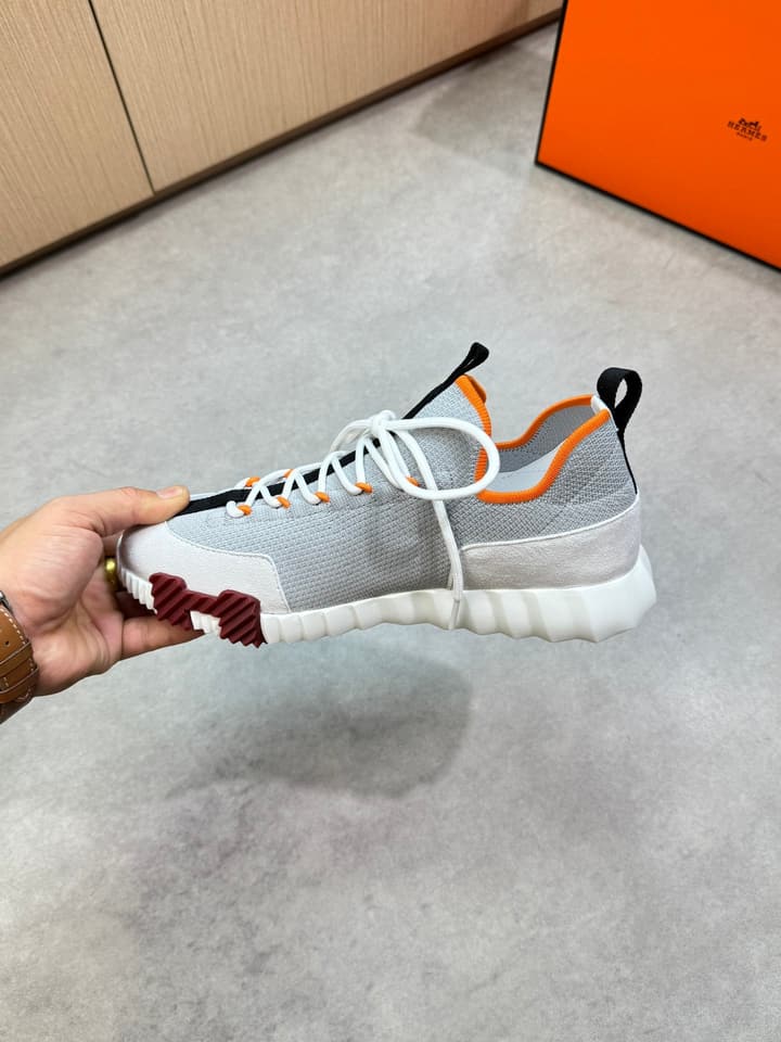 Hermès Casual Sports Sneakers in Black With White Laces And Orange Sole