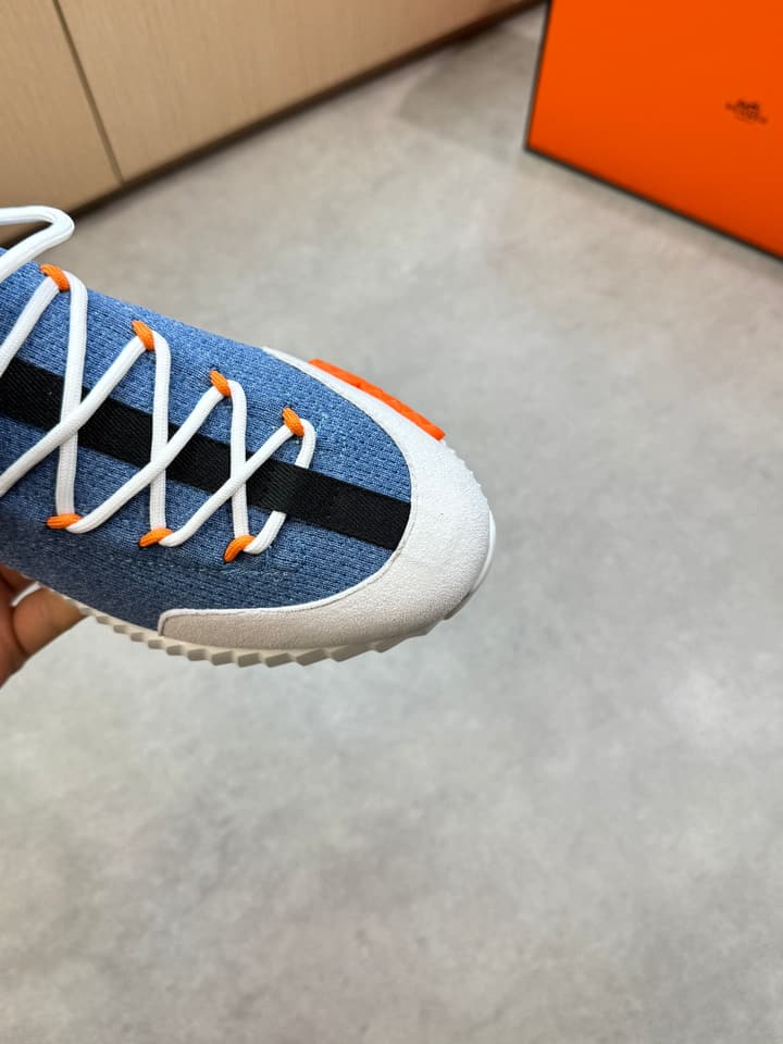 Hermès Casual Sports Sneakers in Black With White Laces And Orange Sole