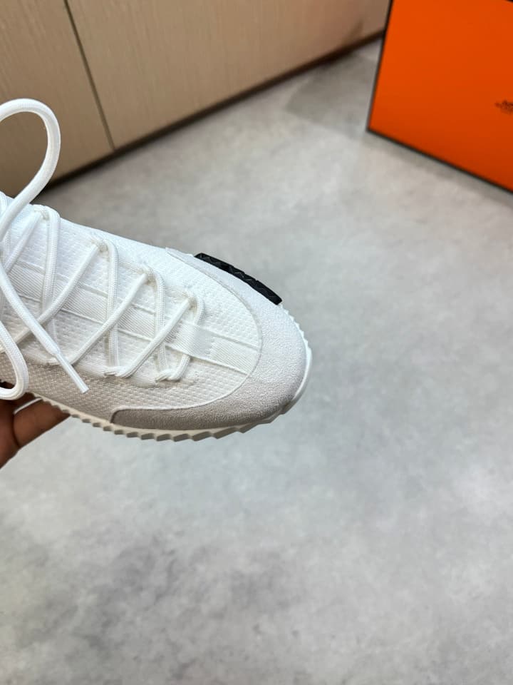 Hermès Casual Sports Sneakers in Black With White Laces And Orange Sole